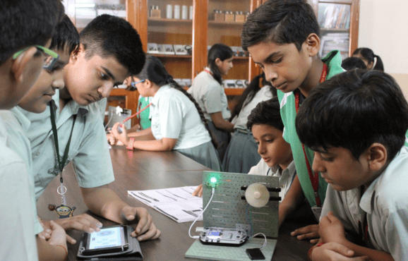 Students from one of the top schools in ghaziabad working on a science experiment with electronics